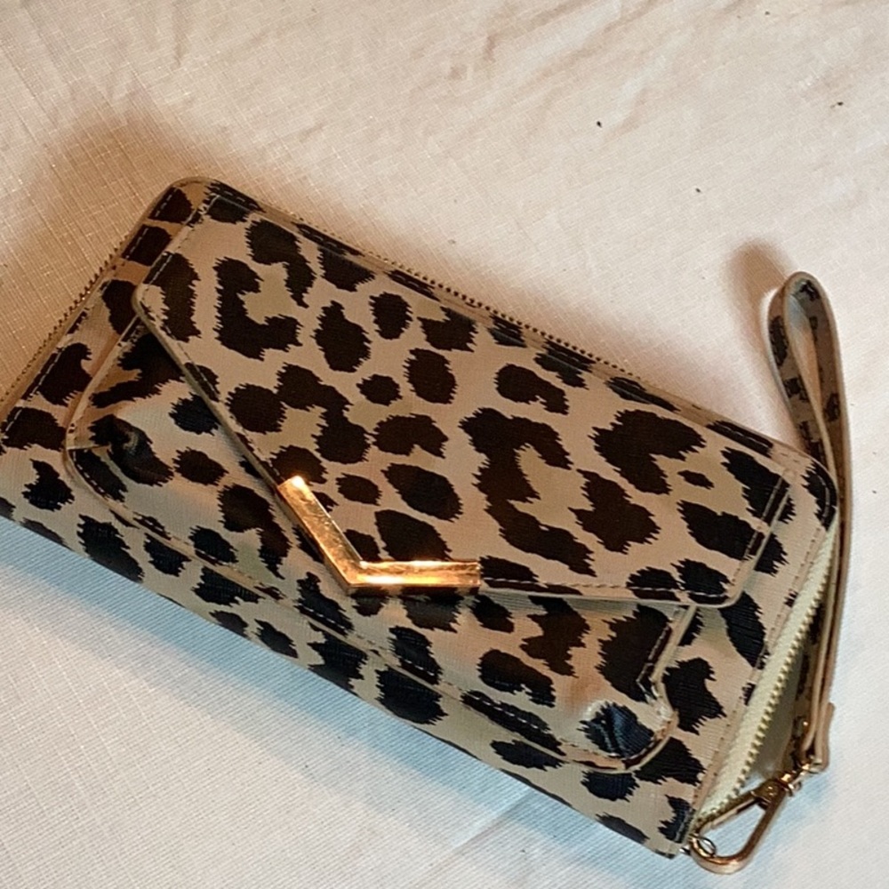 Leopard print Wristlet wallet with multiple compartments.